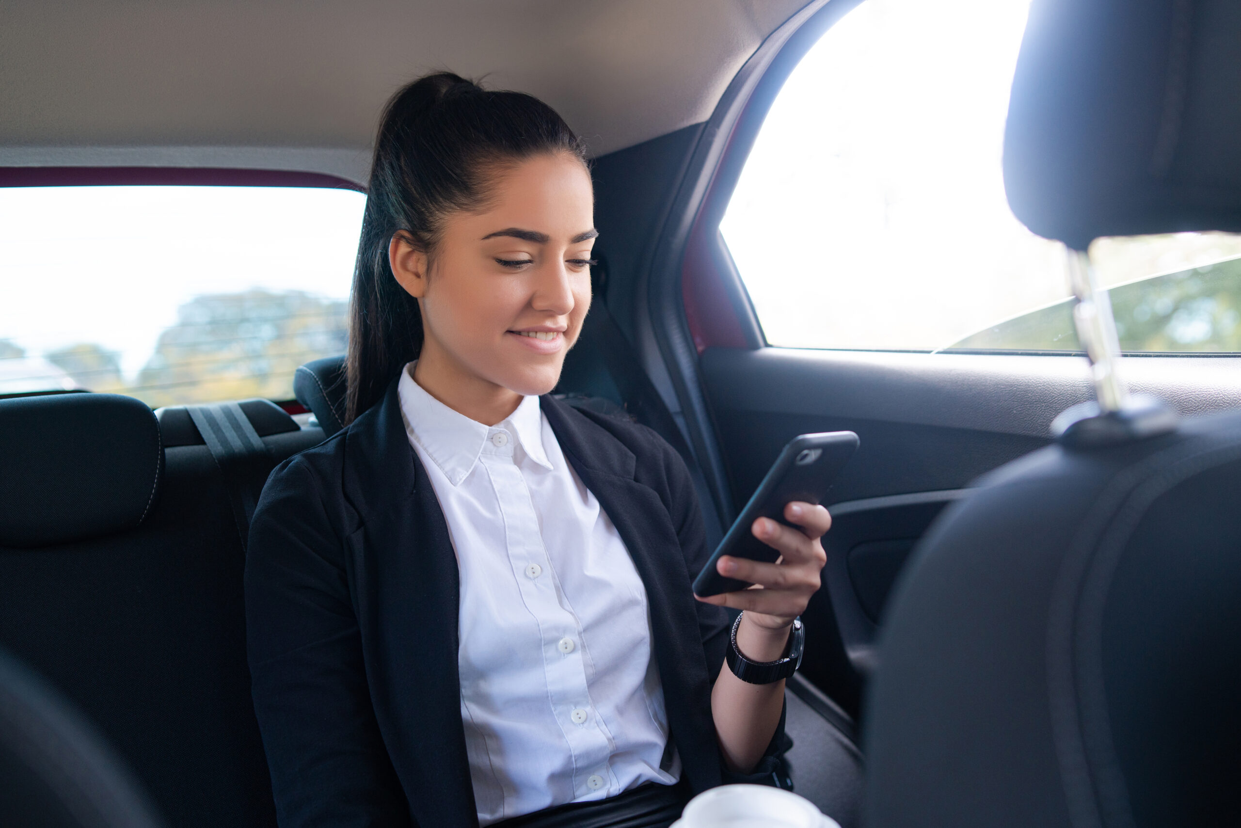 Professional woman on phone in car