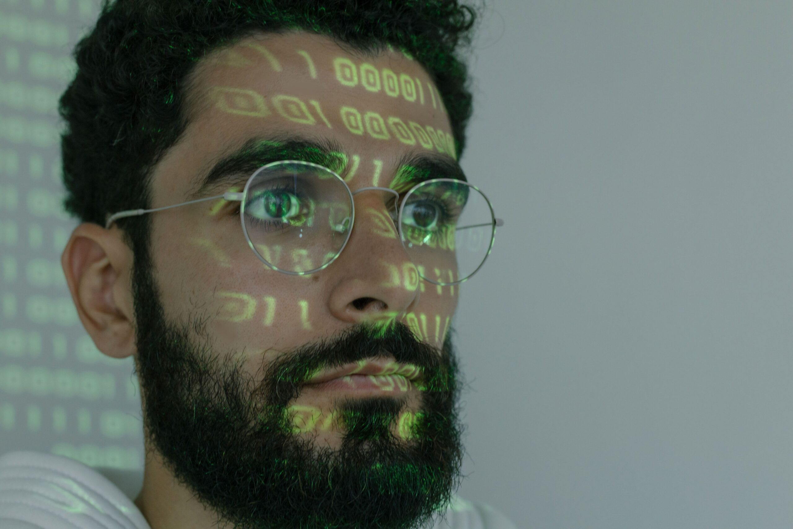 Binary code projected on engineer's face